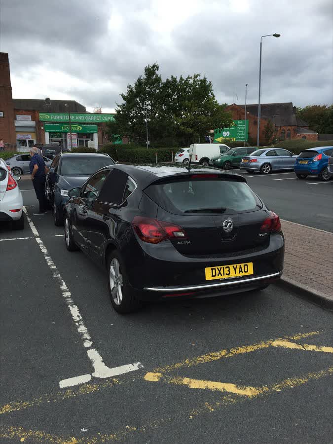 This black 2013 Vauxhall Astra was spotted in a supermarket car park in Redditch, England., close to the Aldi on Trescott Road, Redditch