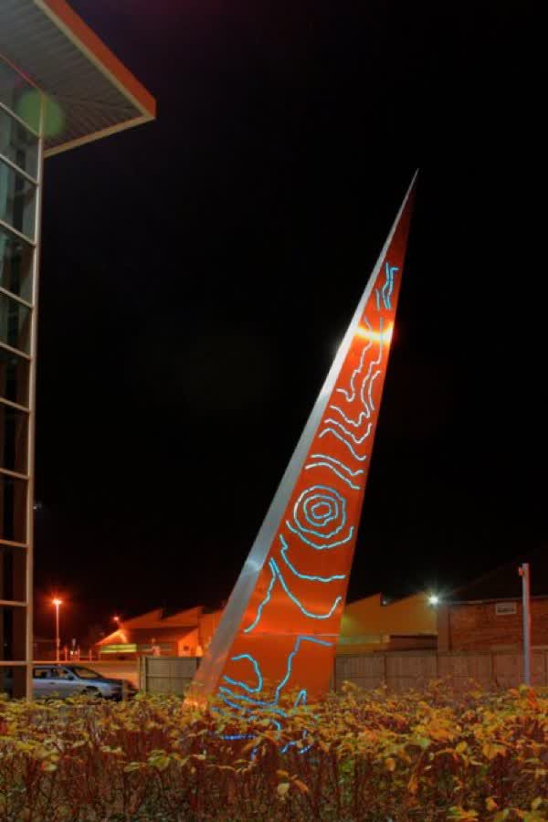 Strata This steel sculpture was recently erected outside the Redcar and Cleveland borough council offices in Rectory Lane. On this face the lights depict the contours of the local landscape which looks very much like Roseberry Topping. If it is Roseberry then only half of it is in Redcar & Cleveland, the other half being in North Yorkshire. The lights change colours from blue through green, red, orange and yellow. On the other face is a similar design but of the artist's finger print. The sculpture was created by Callum Sinclair of Glasgow., close to the Aldi on Hillview Road, Guisborough