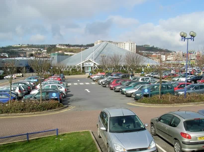 Plantasia, Parc Tawe Plantasia is the pyramidal glasshouse in the centre of the photograph and is located within the Parc Tawe retail and leisure park. The photograph was taken on a busy saturday morning. Most of the local population were doing their shopping in the morning, allowing the afternoon to be free to watch Wales beating England in the Six Nations rugby!, close to the Aldi on Parc Tawe Link Road, Swansea