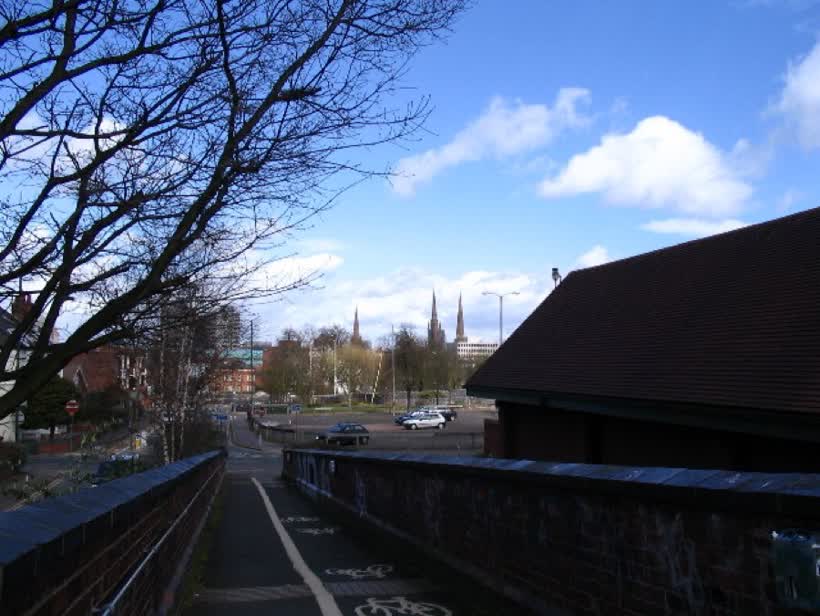 Three spires. Looking down the ramp of 'Anarchy Bridge' towards the city centre and the three spires traditionally associated with Coventry - left, Holy Trinity 36765, centre St. Michael's (the 'old' cathedral 19036 ) and right, Christ Church or Greyfriars ( 288589 ). Directly ahead is Grosvenor Road and the car park is on the site of what is soon to become a 'fabulous new development'., close to the Aldi on Warwick Road, Coventry